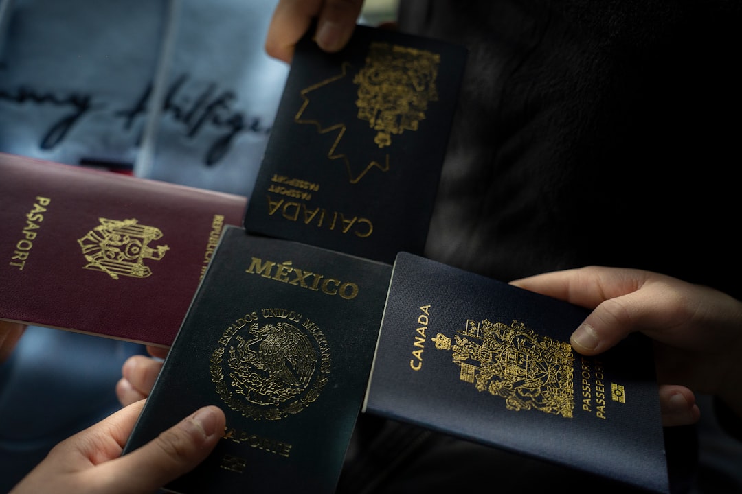 Close-up of travelers holding passports from Canada and Mexico, capturing international travel, airport check-in, and trip planning vibes.